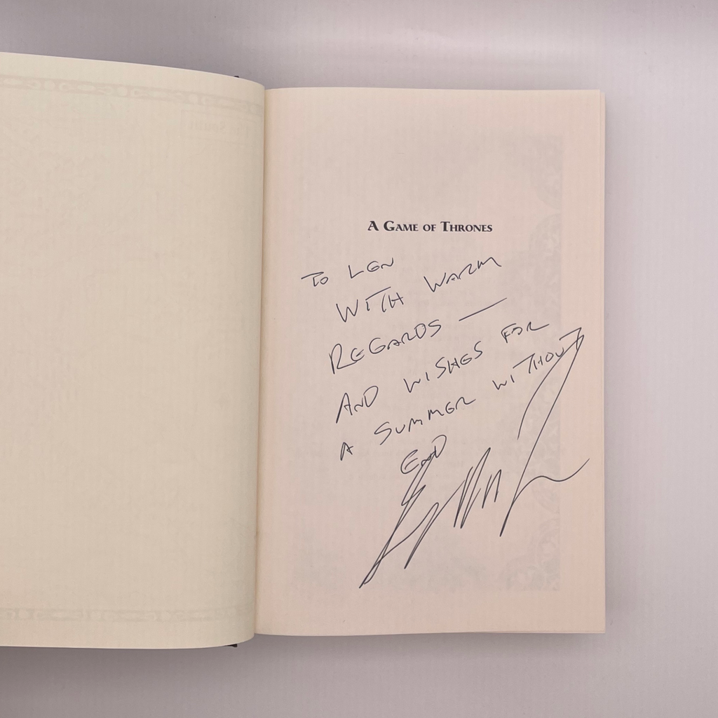 Signed book page from 'A Game of Thrones' with a signature and message.