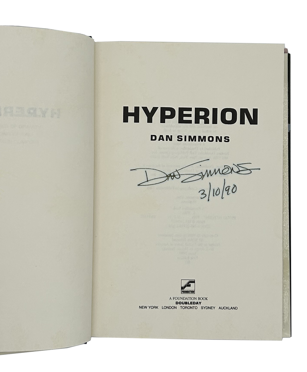 Open book titled 'Hyperion' by Dan Simmons with a signature on a white background